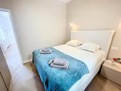 a bedroom with a bed with towels on it at Cannes Vidal Rue Antibes SNCF station 2 mn 1 BR new 2024 quiet building hyper center by Olam Properties in Cannes