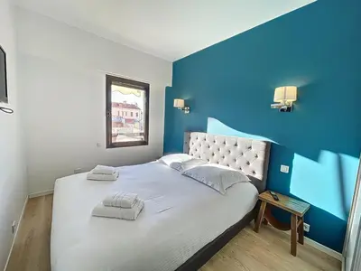 a blue and white bedroom with a large bed at Stunning 1 BR 3 pers Résidence Cannes Suquet Vieux Port Croisette 1 mn by Olam Properties in Cannes