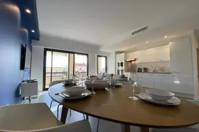 a dining room with a large wooden table and chairs at Stunning 1 BR 3 pers Résidence Cannes Suquet Vieux Port Croisette 1 mn by Olam Properties in Cannes