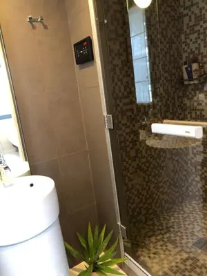 a shower with a glass door in a bathroom at Appartement montfleury, 2 terrasses, 2 chambres , 2 sdb , pkg privé piscine, 15 min walk to Croisette beach and Palais des festivals in Cannes