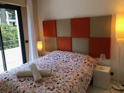a bedroom with a bed with two towels on it at Appartement montfleury, 2 terrasses, 2 chambres , 2 sdb , pkg privé piscine, 15 min walk to Croisette beach and Palais des festivals in Cannes