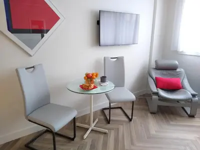 a dining room with a table and two chairs at Studio Cannes Grand Hôtel Eider in Cannes