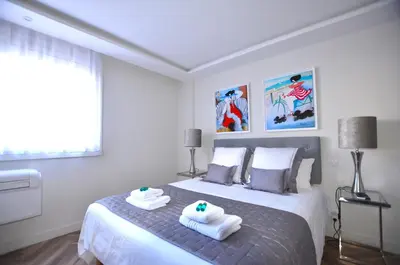 a bedroom with a bed with towels on it at Studio Cannes Grand Hôtel Eider in Cannes