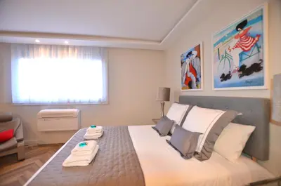 a bedroom with a large bed with towels on it at Studio Cannes Grand Hôtel Eider in Cannes