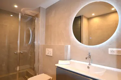 a bathroom with a sink and a shower with a mirror at Studio Cannes Grand Hôtel Eider in Cannes
