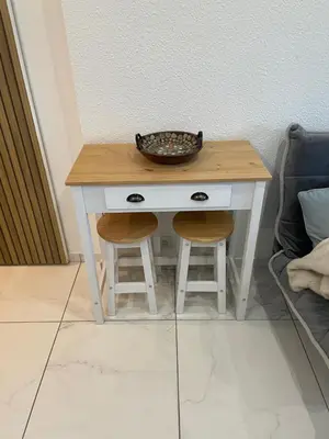 a small table with two stools and a bowl on top at 2 pièces avec terrasse -Calme-Sans vis à vis-garage-centre de Cannes in Cannes