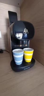 a coffee maker with two cups on a table at 2 pièces avec terrasse -Calme-Sans vis à vis-garage-centre de Cannes in Cannes