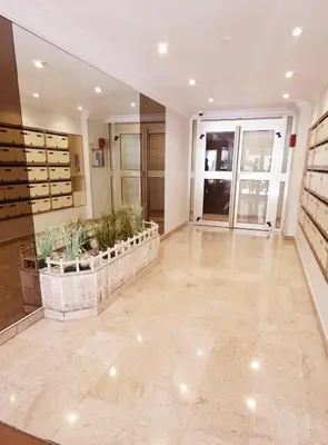 a large lobby with plants in pots in a building at 2 pièces avec terrasse -Calme-Sans vis à vis-garage-centre de Cannes in Cannes