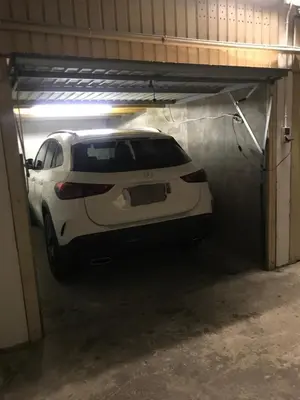 a white car is parked in a garage at 2 pièces avec terrasse -Calme-Sans vis à vis-garage-centre de Cannes in Cannes