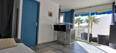 a bedroom with a bed and a view of the ocean at Cannes Pointe Croisette studio plage 2 min à Pieds in Cannes