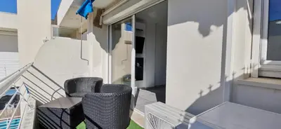 two chairs and a table on the balcony of a house at Cannes Pointe Croisette studio plage 2 min à Pieds in Cannes