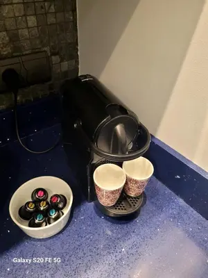 a counter with two cups and a pot and some chocolates at Appartement Cannes Centre - Palais du Festival in Cannes