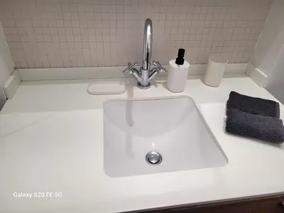a white sink with a faucet on a counter at Appartement Cannes Centre - Palais du Festival in Cannes