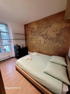 a bedroom with a bed with a map on the wall at Appartement Cannes Centre - Palais du Festival in Cannes