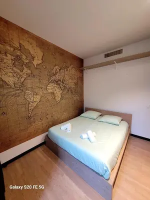 a room with a bed with a map on the wall at Appartement Cannes Centre - Palais du Festival in Cannes