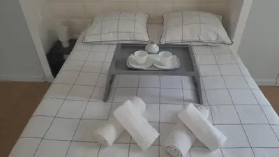 a bed with a coffee table and towels on it at Appartement Cannes Centre - Palais du Festival in Cannes