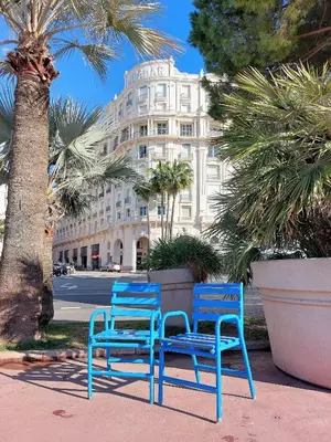 two blue chairs sitting in front of a building at Palais Miramar - Cannes Croisette - Across the Beach - Next to Carlton Hotel in Cannes