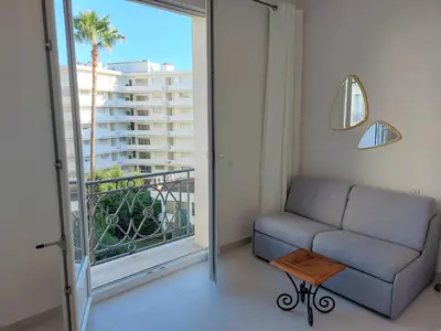 a living room with a couch and a large window at Palais Miramar - Cannes Croisette - Across the Beach - Next to Carlton Hotel in Cannes