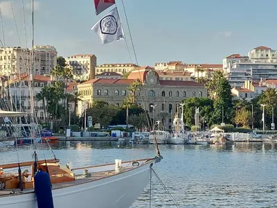 a boat in the water with a city in the background at Palais Miramar - Cannes Croisette - Across the Beach - Next to Carlton Hotel in Cannes