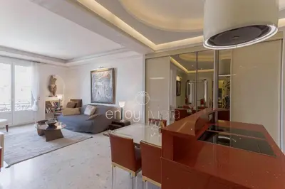a living room with a table and a couch at Palais Miramar Suite Art Modern - Derniere étages Vue Mer - 75m de confort - En Face des Plages -WIFI - Clim in Cannes