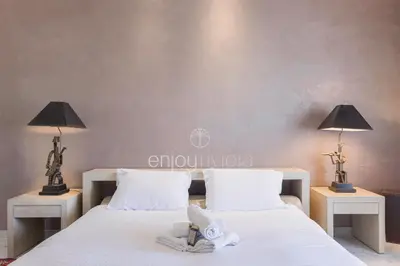 a bedroom with two beds with white sheets and lamps at Palais Miramar Suite Art Modern - Derniere étages Vue Mer - 75m de confort - En Face des Plages -WIFI - Clim in Cannes