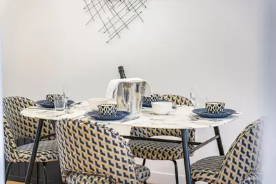 a table with chairs and a tea kettle on it at Elégant - Hypercentre - Croisette - Palais - AK in Cannes
