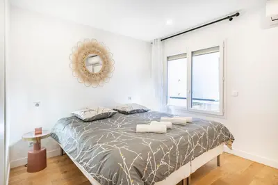 a bedroom with a bed with a mirror and a window at Elégant - Hypercentre - Croisette - Palais - AK in Cannes
