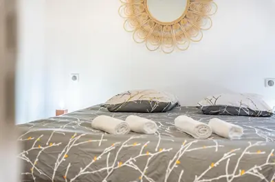 a bed with four pillows and a mirror on the wall at Elégant - Hypercentre - Croisette - Palais - AK in Cannes