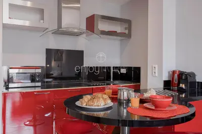 a kitchen with a table with a plate of food on it at Palais Miramar - Suite & B31 - Croisette Emplacement Unique - 20M Plage - WIFI - Clim in Cannes