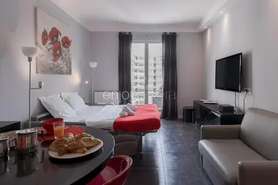 a living room with a bed and a couch and a table at Palais Miramar - Suite & B31 - Croisette Emplacement Unique - 20M Plage - WIFI - Clim in Cannes