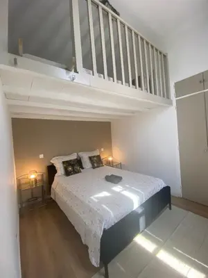 a bedroom with a bed and a loft at Joli appartement à 5 minutes du palais et plages in Cannes