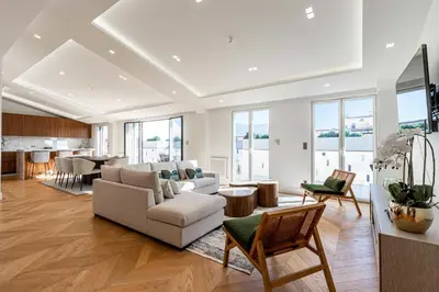 a living room with a couch and a table at Sumptuous renovated Penthouse - Gray d'Albion-Croi in Cannes