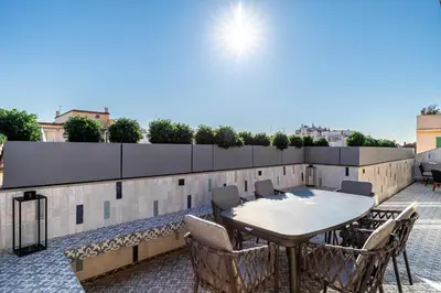 a patio with a table and chairs on a roof at Sumptuous renovated Penthouse - Gray d'Albion-Croi in Cannes