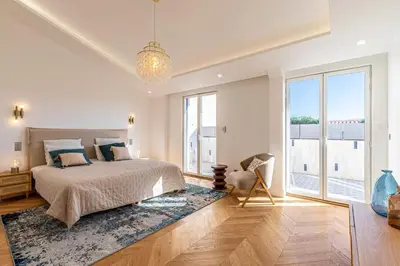 a bedroom with a bed and a large window at Sumptuous renovated Penthouse - Gray d'Albion-Croi in Cannes
