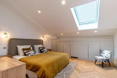 a bedroom with a large bed and a skylight at Sumptuous renovated Penthouse - Gray d'Albion-Croi in Cannes