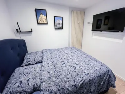a bedroom with a bed and a tv on the wall at CROISETTE VUE MER LATERALE in Cannes