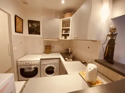 a kitchen with a washing machine and a sink at 2 bedroom apartment in the heart of Cannes air conditioning easy walk to the Palais des Festivals - 2015 in Cannes