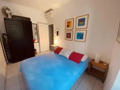 a bedroom with a blue bed in a room at 2 bedroom apartment in the heart of Cannes air conditioning easy walk to the Palais des Festivals - 2015 in Cannes