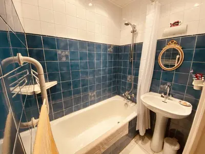 a blue tiled bathroom with a tub and a sink at 2 bedroom apartment in the heart of Cannes air conditioning easy walk to the Palais des Festivals - 2015 in Cannes