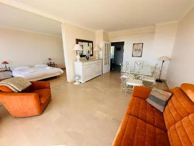 a living room with a couch and a bed at Large, light and modern 2 bedroomed apartment in Cannes with Sea Views, pool and lovely terrace - 1503 in Cannes