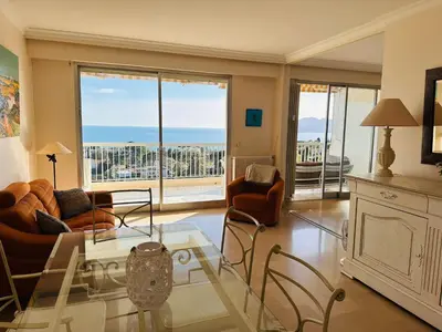 a living room with a view of the ocean at Large, light and modern 2 bedroomed apartment in Cannes with Sea Views, pool and lovely terrace - 1503 in Cannes
