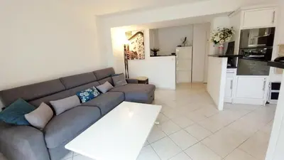 a living room with a couch and a table at Le Fragonard in Cannes