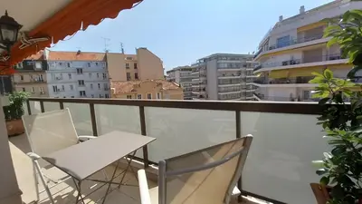 a balcony with two chairs and a table on a balcony at Le Fragonard in Cannes