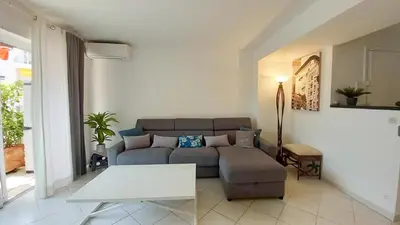 a living room with a couch and a table at Le Fragonard in Cannes