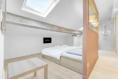 a white bedroom with a bed and a window at 2 Bed - Ascenseur - 2 min du Palais - Climatisé in Cannes