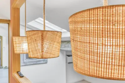 three wicker chandeliers hanging in a room at 2 Bed - Ascenseur - 2 min du Palais - Climatisé in Cannes