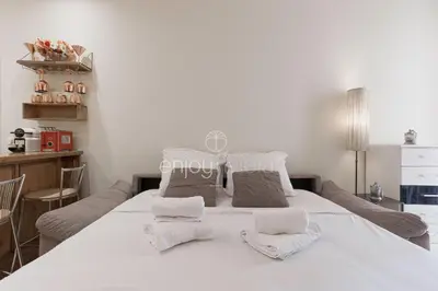 a bedroom with a large white bed with towels on it at Palais Miramar - Suite & E37 - 20M Plage - Croisette Emplacement Unique - WIFI - Clim in Cannes