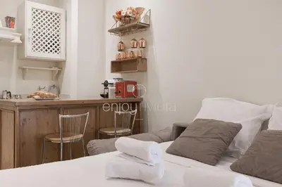 a bedroom with a bed and a kitchen with a counter at Palais Miramar - Suite & E37 - 20M Plage - Croisette Emplacement Unique - WIFI - Clim in Cannes