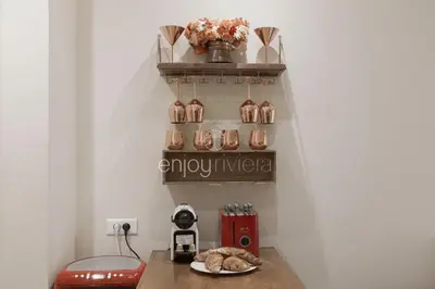 a room with a table and a shelf with vases at Palais Miramar - Suite & E37 - 20M Plage - Croisette Emplacement Unique - WIFI - Clim in Cannes
