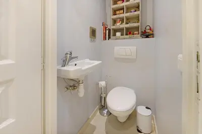 a white bathroom with a toilet and a sink at Palais Miramar - Suite & E37 - 20M Plage - Croisette Emplacement Unique - WIFI - Clim in Cannes